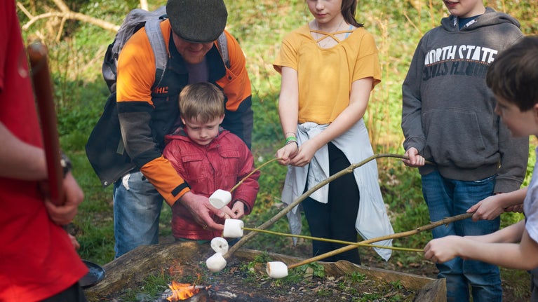 Children toasting marshmallows on a campfire